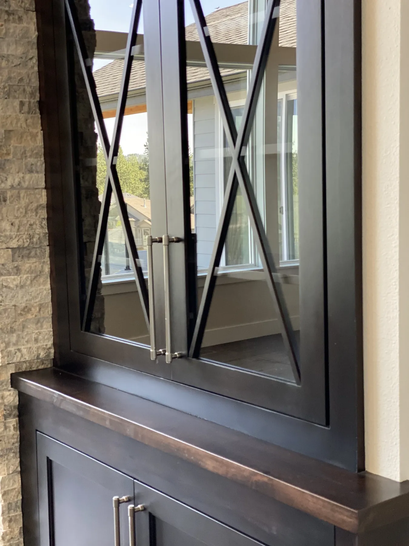 Mullioned glass cabinetry: Stained built-ins with cross-bar glass fronts.